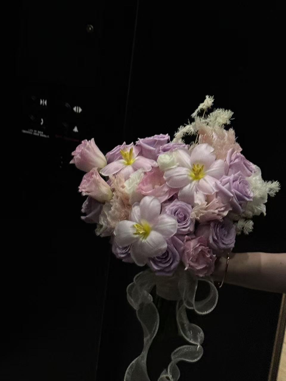 Pink and purple designed bouquet of flowers