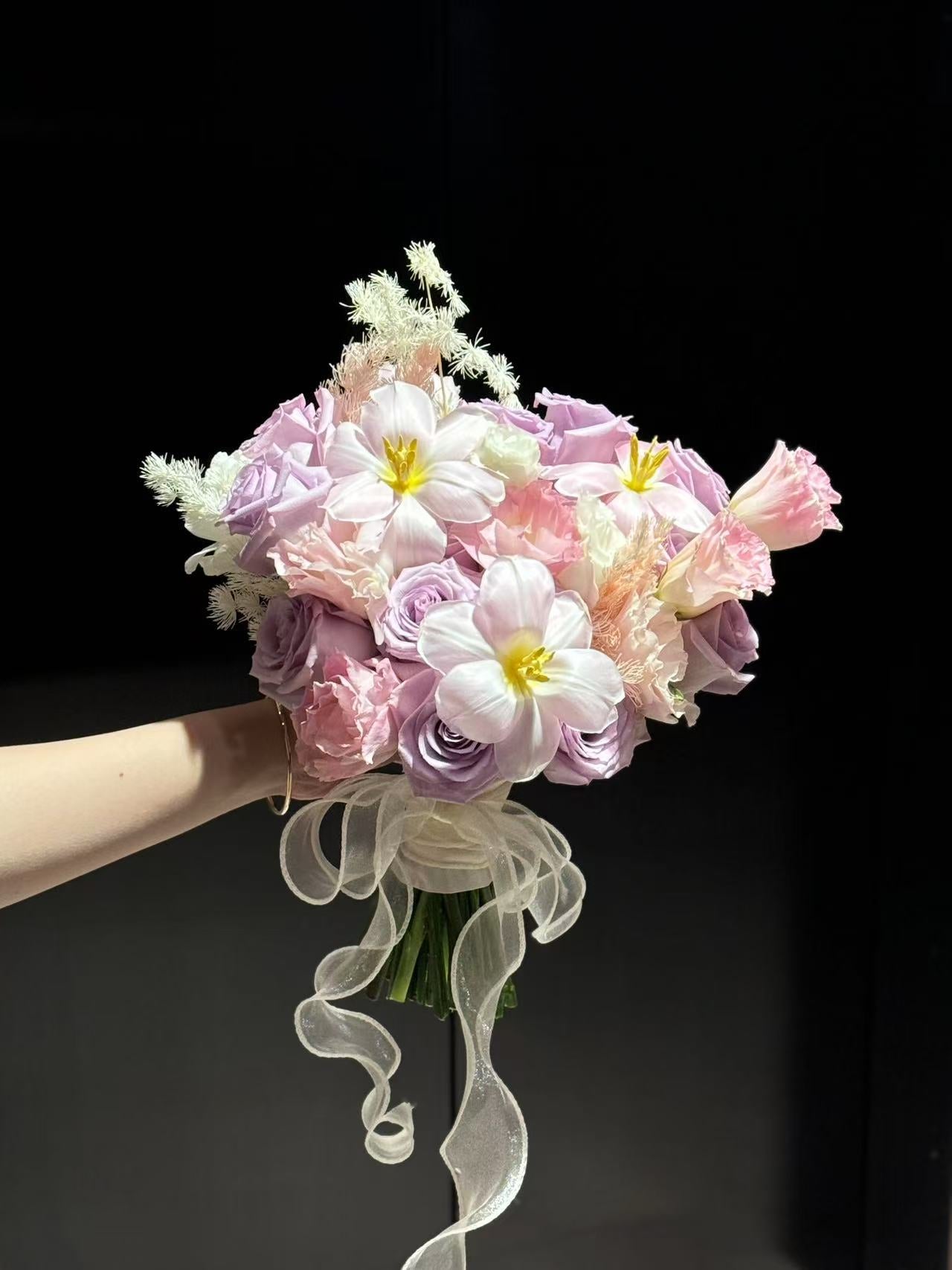Pink and purple designed bouquet of flowers