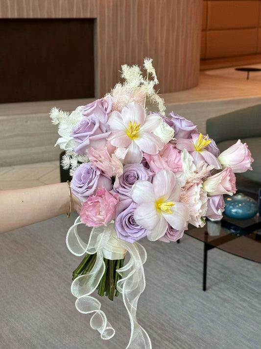Pink and purple designed bouquet of flowers